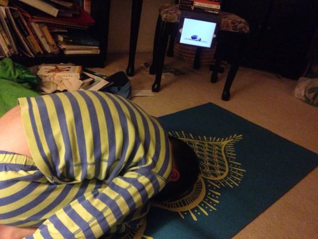 Thing 3 and his mat and his yoga app. 